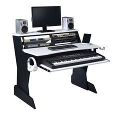 a computer desk with a keyboard, monitor and headphones on it's stand