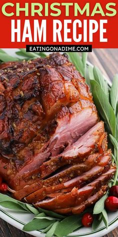 a ham is sitting on a plate with holly leaves around it and the words, christmas ham recipe