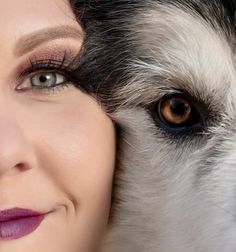 a close up of a person with a dog behind her and the woman's face