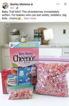 two bags of cereal sitting on top of a counter next to a box of candy