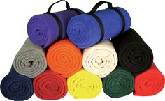 several colors of yoga mats stacked on top of each other in different sizes and shapes