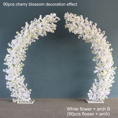 two white flowers are arranged in the shape of an arch