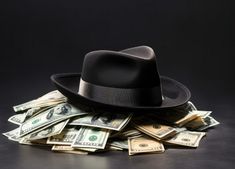 a pile of money with a black hat on top