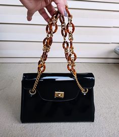 Vintage Black Patent Leather Purse with Tortoise & Gold Chains The over all size of the handbag         is 9" long by 6" tall and the side at the widest point is 4 1/2 " wide         with the drop of the Chain to the bottom of the purse is 13" long The Purse is in good condition ...it is used ..         .but i have treated it like gold since i have had it ...          and got many compliments on it .. The inside of the purse is clean ..it is lined with Black grow grain Fabric          with 2 pockets on one side           and a zipper pocket on the other side Elegant Evening Bags In Tortoiseshell, Purse Strap, Saint Louis, Black Patent Leather, Tote Backpack, Leather Purse, Leather Purses, Tortoise, Gold Chain