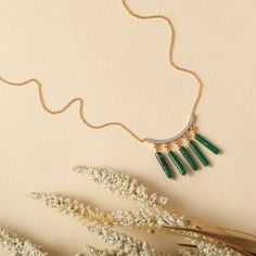 Description : Inspired by the beautifully patterned Malachite gemstone, the earliest ore of copper, Tamra is eccentric, contemporary, and distinctively classy. Handcrafted on 925 hallmark silver and gold finish. This collection is curated for everyday luxury.This minimal charm necklace features a line charm studded with CZ stones. Five malachite charms are suspended from the chain for a striking everyday style. Product Information : Materials used: 925 Silver with Gold & White Gold Plating Stone Everyday Luxury, Charm Necklace Silver, Cz Stone, Silver And Gold, Everyday Style, Gold Plating, Gold Finish, Hallmark, Charm Necklace