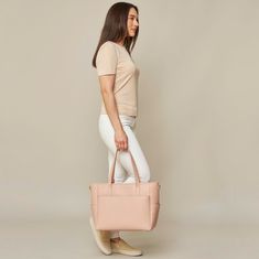 This structured tote is the ultimate do-it-all bag that you deserve. It's the perfect carryall for work, travel, and anywhere your day brings you. It features a spacious and organized interior for your essentials, a padded compartment for your laptop, side pockets for your drinks, and you can convert it into a backpack or crossbody. Crafted from premium American Saffiano leather that's waterproof and scratch-resistant, the Transform Tote will stay just as beautiful through all your travels and a Feminine Rectangular Bag For On-the-go, Chic Tote Laptop Bag For On-the-go, Modern Everyday Laptop Bag With Detachable Handle, Workwear Tote Bag With Interior Card Slots, Modern Laptop Bag With Detachable Handle For Everyday, Chic Laptop Bag With Top Carry Handle For On-the-go, Everyday Diaper Bag Tote With Detachable Handle, Travel Diaper Bag With Detachable Handle In Tote Shape, Everyday Diaper Bag With Detachable Handle Tote