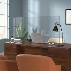 an office with a desk, chair and lamp