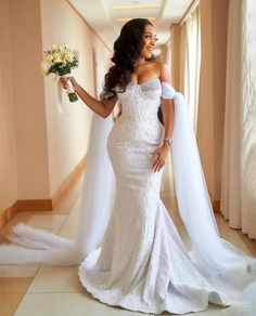 a woman in a wedding dress holding flowers