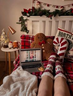 a person laying in bed with their feet up on a laptop