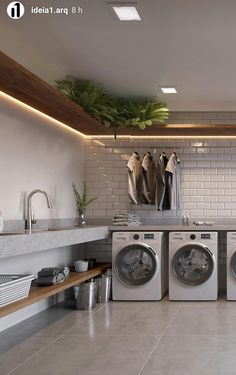 a washer and dryer in a room with tiled walls, flooring and lighting