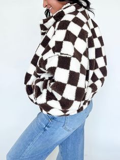 Wrap yourself in warmth and style with our Checkmate Sherpa Jacket, a perfect blend of cozy comfort and timeless design. This jacket features a classic checkered pattern that brings a touch of vintage charm and trend to your wardrobe, while the soft fleece fabric ensures you stay warm on chilly days. Whether you're heading out for a brisk walk or lounging by the fire, this jacket offers the perfect combination of functionality and flair. Oversized Brown And White Check Printed Puffed Sherpa Jack Trendy Gingham Long Sleeve Outerwear, Fall Gingham Outerwear With Long Sleeves, Brisk Walk, Sherpa Jacket, Checkered Pattern, Comforters Cozy, Vintage Charms, Fleece Fabric, Matching Sets