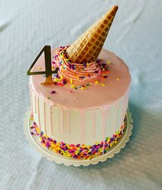 a birthday cake with an ice cream cone on top