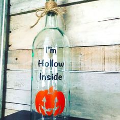 a glass bottle with an i'm hollow inside painted on it