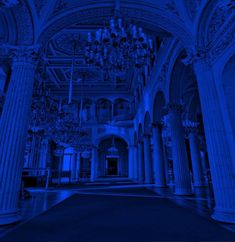 the inside of a building with columns and chandeliers