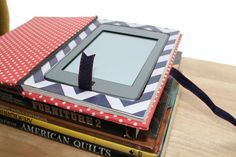 a stack of books with an electronic device on top