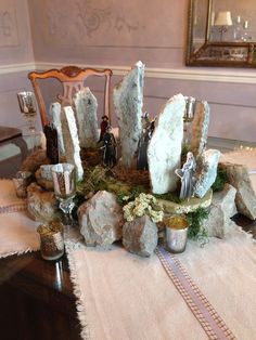 a table topped with rocks and candles