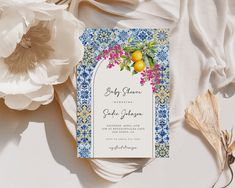 an image of a wedding card with lemons on it and flowers in the background