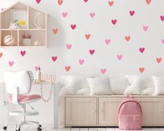 a child's room with pink and red hearts on the wall, along with white furniture