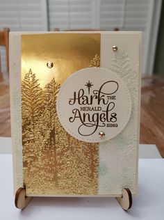 a card with gold foil on it and the words, mark the herald angels sing