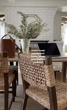 a dining room table with chairs and a vase on it