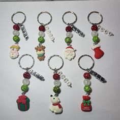 a bunch of key chains that have christmas themed items attached to them, sitting on top of a table