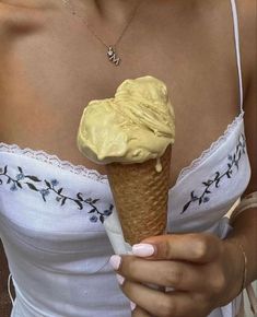 a woman holding an ice cream cone in her hand