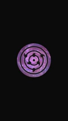 a purple and black circular object in the dark