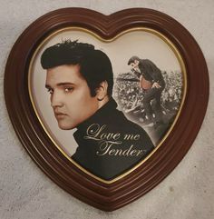 a heart - shaped plaque with a photo of elvis presley in the center and words love me tender on it