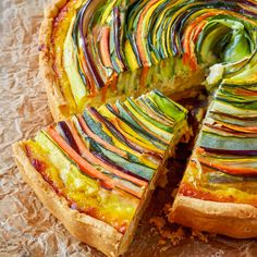 a colorful vegetable pie with one slice cut out and ready to be eaten on the table