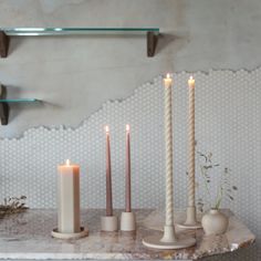 some candles are sitting on a marble table