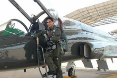 a man standing in the doorway of an airplane