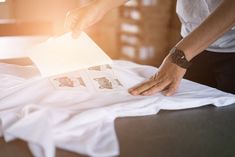 a person placing pictures on top of a bed