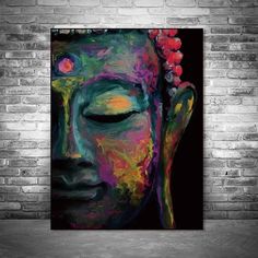 a buddha painting on a brick wall