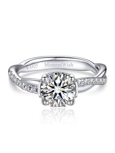 a diamond engagement ring with the words moment wish on it's side and an engraved band