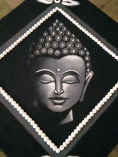 there is a black and white image on the floor with beads around it's head