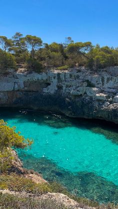 the water is crystal blue and clear at this point in the ocean near some cliffs