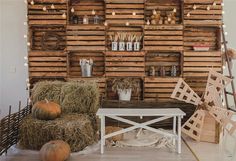 a living room filled with hay bales and pumpkins