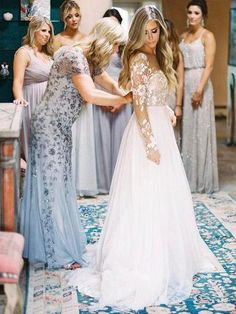 two women in long dresses standing next to each other