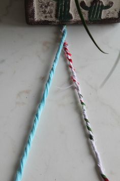 two crocheted toothbrushes are next to each other on a counter top