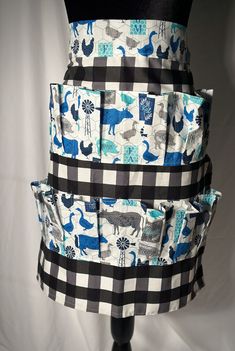 a black and white checkerboard dress with blue animals on the front, along with matching pockets