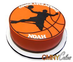 a cake that is shaped like a basketball player with the words noah on it and an orange background