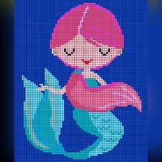 a cross stitch pattern of a little mermaid with pink hair holding a blue fish in her hands