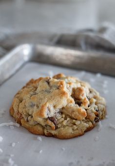 an oatmeal chocolate chip cookie on a baking sheet