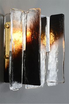 a light that is on the side of a wall next to some glass blocks and lights