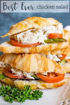 three croissant sandwiches stacked on top of each other with cheese and tomato slices