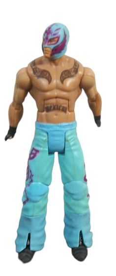 a toy wrestler with blue pants and tattoos on his chest