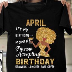 a woman holding up a black shirt with the words, it's my birthday month i