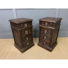 pair of carved wooden nightstands on carpeted floor