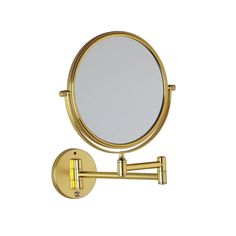 a gold wall mounted magnifying mirror on a white background