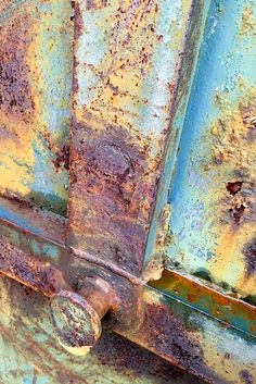 an old rusted metal door with rivets on it